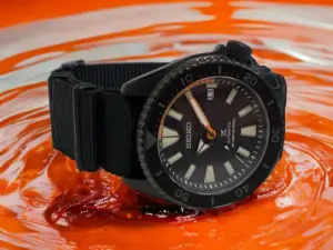 Learn how this watch adds a touch of style and individuality with its striking black dial and bright orange accents.